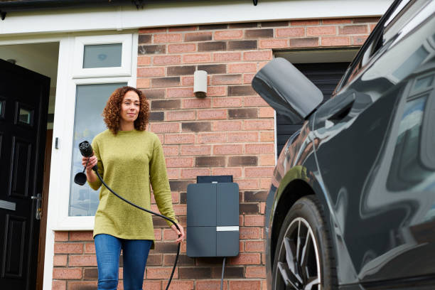 Person conveniently plugging in their electric vehicle at home