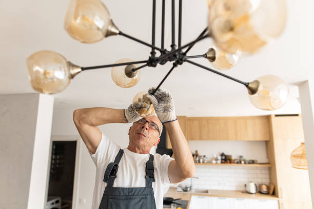 Electrician installing modern interior lighting in North Fort Myers, FL
